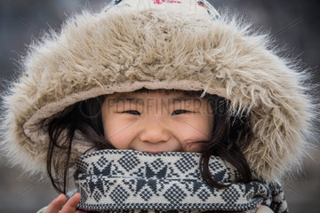 Korean teenager in Seoul street in winter  wearing a hat