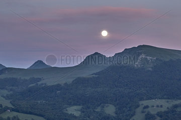 Full Moon above the Cantal Mountains  Regional Natural Park of the Auvergne Volcanoes  France