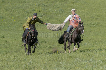 Mongolians traditionnaly dressed on a horse  traditional exercise of address  Bashang Grassland  Zhangjiakou  Hebei Province  Inner Mongolia  China
