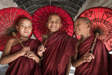 Teen Buddhist monks in Burma in Bagan city in Sweshigone pagoda