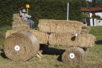 Tractor made with straw stacks in a field France
