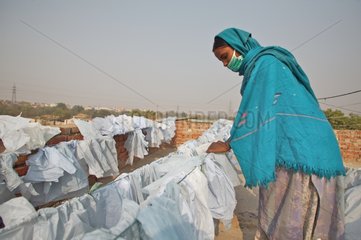 Drying of plastic bags collected in the street India