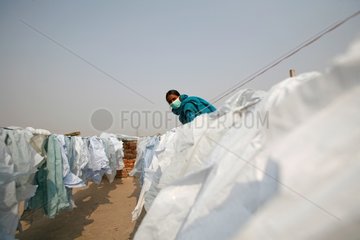 Drying of plastic bags collected in the street India