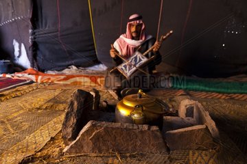 Bedouin playing an instrument in a tent in Jordan