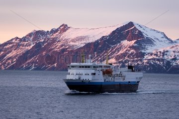 Cruise boat on the coast at twilight Norway
