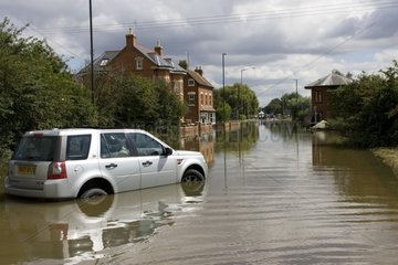 Car partly submerged on a flooded road UK