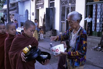Young novices receiving offerings Rangoon Myanmar