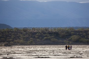 Masai walking on the shores of Lake Magadi soda Kenya