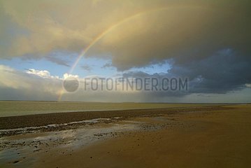 Rainbow on a sand beach in the Somme Bay France