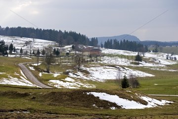 Farmhouse in Jura and snowmelt in the spring