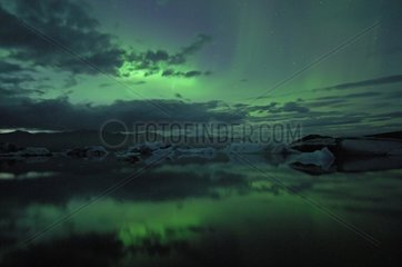 Aurora borealis reflecting on Joekulsárlón lake Iceland