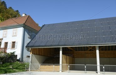 Shed for storage of wood covered with solar panels France