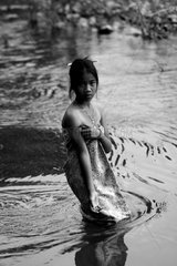 Young girl doing her toilet in the Mekong River Cambodia