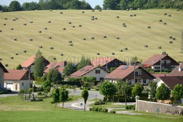 Village and haystacks in a meadow of Haut-Doubs - France
