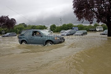 Cars driven on a flooded road in Tewkesbury UK