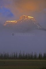 Peak in the clouds in the evening light Canada