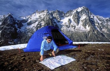 Hiker and his tent on the Mont de la Saxe Italy