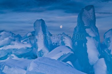 Abstract view of ice blocks and moonrise Minnesota USA
