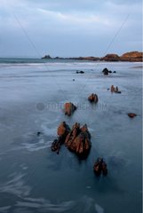 Rising tide on the coasts of Armor at the sunset Bretagne