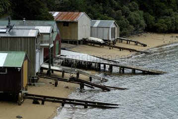 Boat sheds on a beach of Stewart island New Zealand