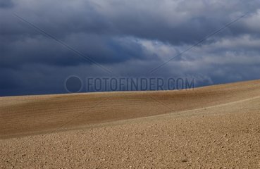 Plowed cereal field and thundery weather Spain