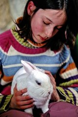 Young girl cherishing her dwarf rabbit