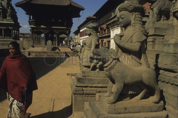 Rule representing a woman and her dog in a village Nepal