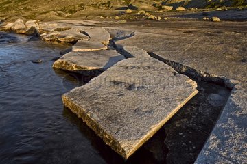 Flagstone fracturing itself in edge of river Norway