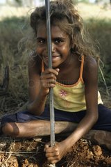 Aborginal girl hunting sand monitor in Australia