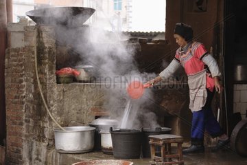 Woman cooking with Yuangyang Yunnan China