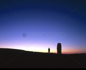 Man and Moon rising close to a menhir Lozere Mount