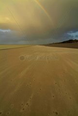 Rainbow on a sand beach in the Somme Bay France