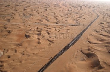 Road crossing the sand desert United Arab Emirates