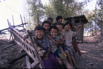 hildren sitting on a plough Area of the lake Inle Myanmar