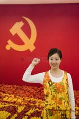 Woman in front of the flag of the Communist Party in Shanghai