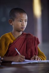 Young monk reviewing his lessons Monastery Nyaungshwe
