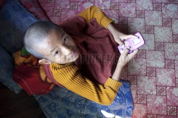 Young monk playing and no battery game Nyaungshwe Monastery
