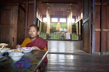 Young monk eating his breakfast Nyaungshwe monastery