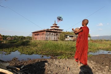 Young monk and Kite Monastery on stilts Nyaungshwe