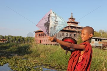Young monk and Kite Monastery on stilts Nyaungshwe