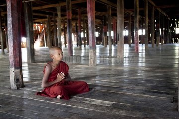 Young monk in meditation position Monastery Nyaungshwe