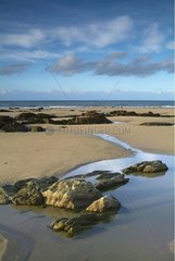 Rocks and puddle pools on a beach of Finistere France