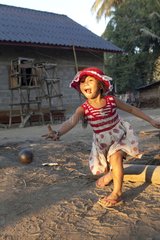 Child playing petanque aound Luang Prabang in Laos