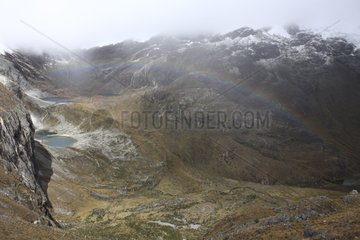 Rainbow before the massive Yanapaccha Andes Peru