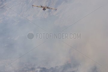 Tanker plane in the smoke of a fire in Corsica in July