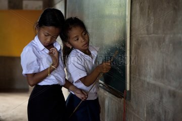 Girls playing the mistress of a school in Laos