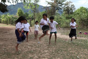 Girls in sarong playing the dodgeball in Laos