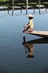 Woman in front of his boat on Inle Lake Burma