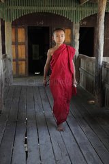 Child walking on a catwalk of a monastery Burma