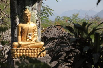 Buddha statue in the gardens of Mount Phou Si in Laos